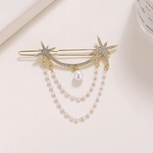 Detail of gold star hair clip with layered pearl tassels and sparkling rhinestones