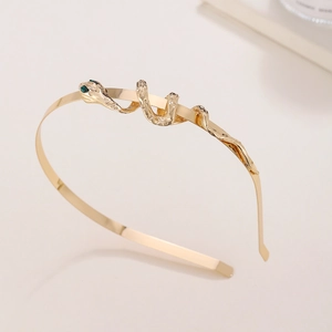 Elegant gold metal snake headband with green gem eyes for women's luxury fashion