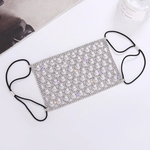 Detailed view of luxury silver mesh face mask with white pearls and sparkling rhinestones