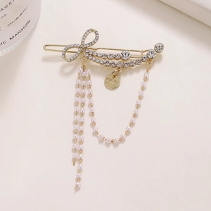 Elegant gold bow hair clip with sparkling rhinestones and dangling pearl tassel chains