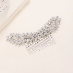 Elegant silver baroque leaf hair comb with intricate metallic textures for wedding hairstyles