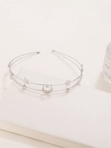 Close-up of double-layered silver headband with sparkling star and moon pendants