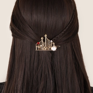 Exquisite golden castle hair clip with a large pearl, red gemstone and sparkling rhinestones