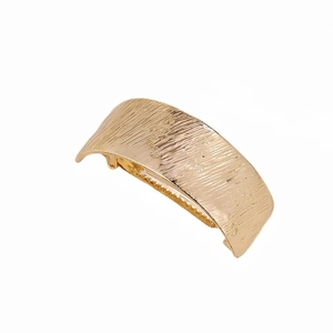 Minimalist gold metal curved ponytail spring hair clip with a brushed textured finish