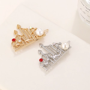 Macro detail of palace crown hair clips with pearls, red rhinestones and stars