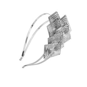 Macro detail of silver double-layered metal headband featuring square radial texture plates