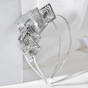 Elegant silver metal leaf headband with overlapping geometric diamond-shaped carved details