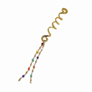 Close-up of golden spiral hair ring with colorful stone beads and long tassel detail