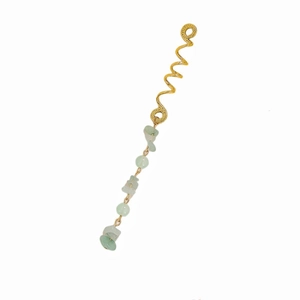 Detail of gold hammer-textured amo letter pendant with light green gemstone beads