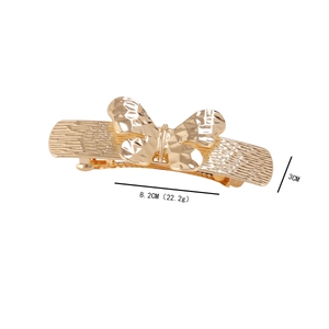Detailed view of a vintage hollow gold butterfly hair clip measuring 8.2cm by 3cm
