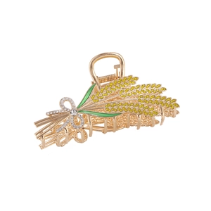 Pince à cheveux dorée en forme de blé avec cristaux jaunes et nœud en strass brillant
