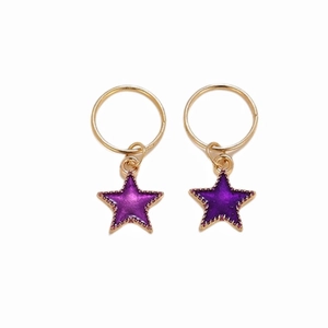 Detailed macro view of golden star hair cuffs with purple glitter resin inlay pendants