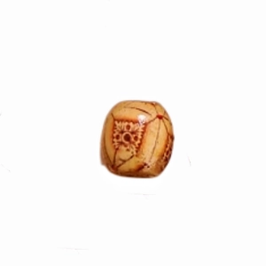 Macro detail of retro carved wooden dreadlock bead with brown floral DIY accessory patterns