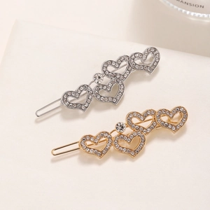 Elegant gold and silver heart-shaped hair clips with sparkling rhinestones set of two