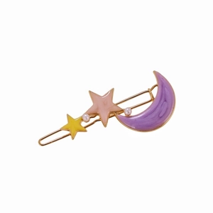 Detail of flower hair clip with purple marble moon and colorful stars and white pearls