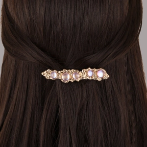 Fermaglio per capelli vintage dorato con pietre viola iridescenti dal design sobrio