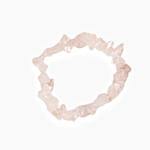 Macro view showing the natural irregular clear quartz beads and elastic cord detail