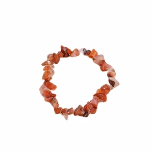 Macro shot of natural red agate chip bracelet with irregular translucent orange stones