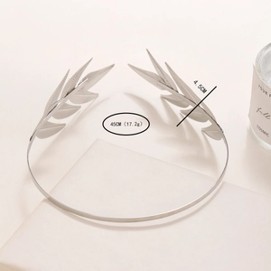 Close-up of silver metal leaf headband with 45cm length and detailed feather texture
