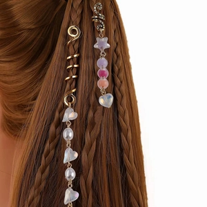 Golden spiral hair rings with pearls and heart beads on dark brown braids accessory