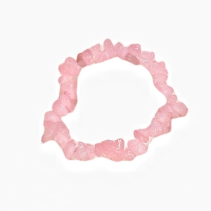 Macro shot of irregular polished pink crystal beads on a natural gemstone bracelet