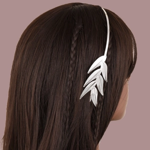 Detail view of silver alloy leaf headband with intricate hollowed-out texture on hair