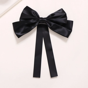 Elegant large black satin bow hair clip with long ribbons in French minimalist style