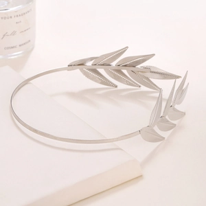 Detailed close-up of silver metal leaf headband showing intricate botanical textures