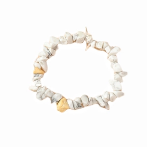 Macro detail of irregular white turquoise crushed stone bracelet with grey marble texture