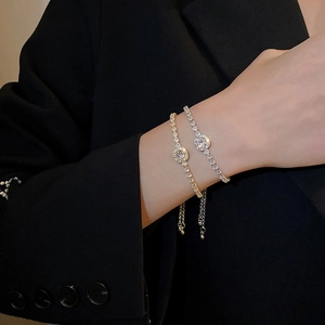 Macro detail of adjustable gold and silver bracelets with round brilliant cut cubic zirconia