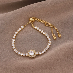 Elegant gold adjustable bracelet featuring square zircon and round brilliant cut crystals