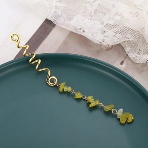 Golden spiral hair charm with light green natural stone beads on a vintage lace setting