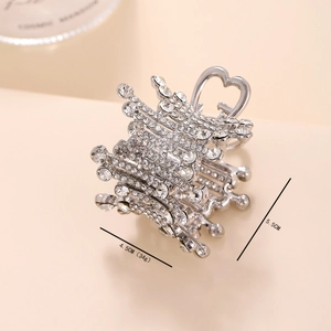 Detail view showing a 4.5cm length and 5.5cm height silver pearl hair claw with rhinestones