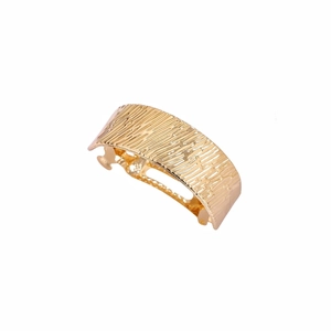 Textured gold arc hair clip with a brushed metal surface and spring mechanism