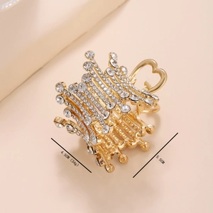 Detailed view of a heart-shaped pearl hair claw with crystal rhinestones and sizing info