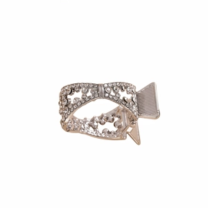Close-up of silver metal hair claw clip with rhinestone bow design and spring detail
