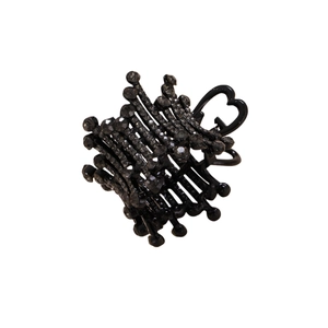Close-up of black claw clip with inlaid rhinestones and elegant crown design