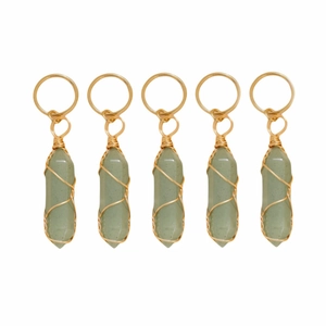 Detail of five green quartz crystal charms wrapped in golden wire for hair accessories