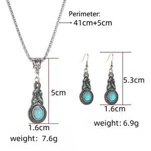 Vintage jewelry set with turquoise necklace and blue rhinestone earrings on white background