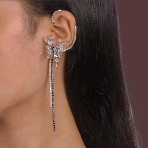 Close-up of silver butterfly ear cuff with sparkling rhinestone tassel chains on ear