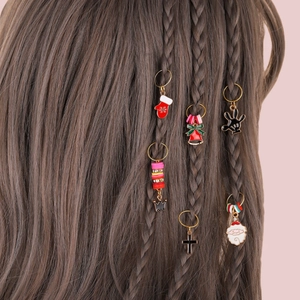 Detail shot of Christmas themed hair charms and rings used in a braided hairstyle