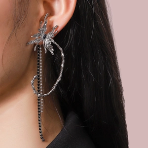 Detail of silver liquid metal butterfly earring with black stones and long tassels