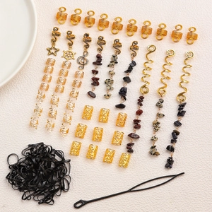 Macro detail of dreadlock accessories set featuring natural stones and gold spiral hair clips