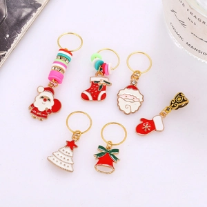 Detail of Christmas enamel alloy hair rings featuring Santa, stockings and festive charms