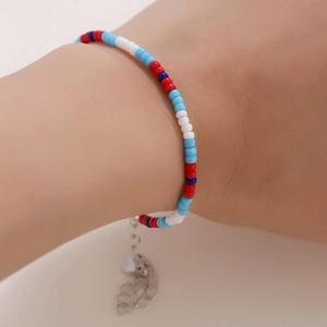 Detail of colorful glass seed bead bracelet with adjustable silver chain on wrist