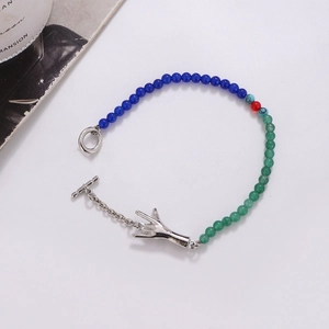 Handmade emerald glass bead bracelet with silver palm charm and toggle clasp