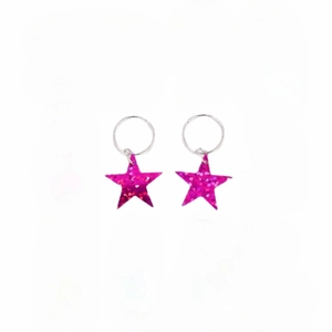 Detailed macro view of pink sequin star pendants on silver metallic hair ring accessories