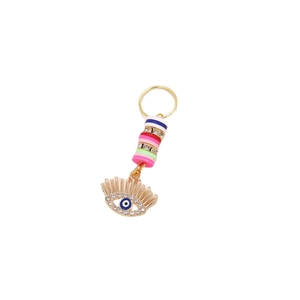 Macro shot of boho Evil Eye hair charm with colorful beads and crystal pendant