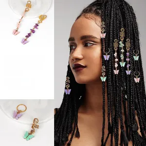 Detail view of butterfly dreadlock hair rings with natural stones and gold spiral coils