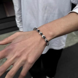 Detail of hip hop style tennis bracelet with black stones and paved zircon links on wrist